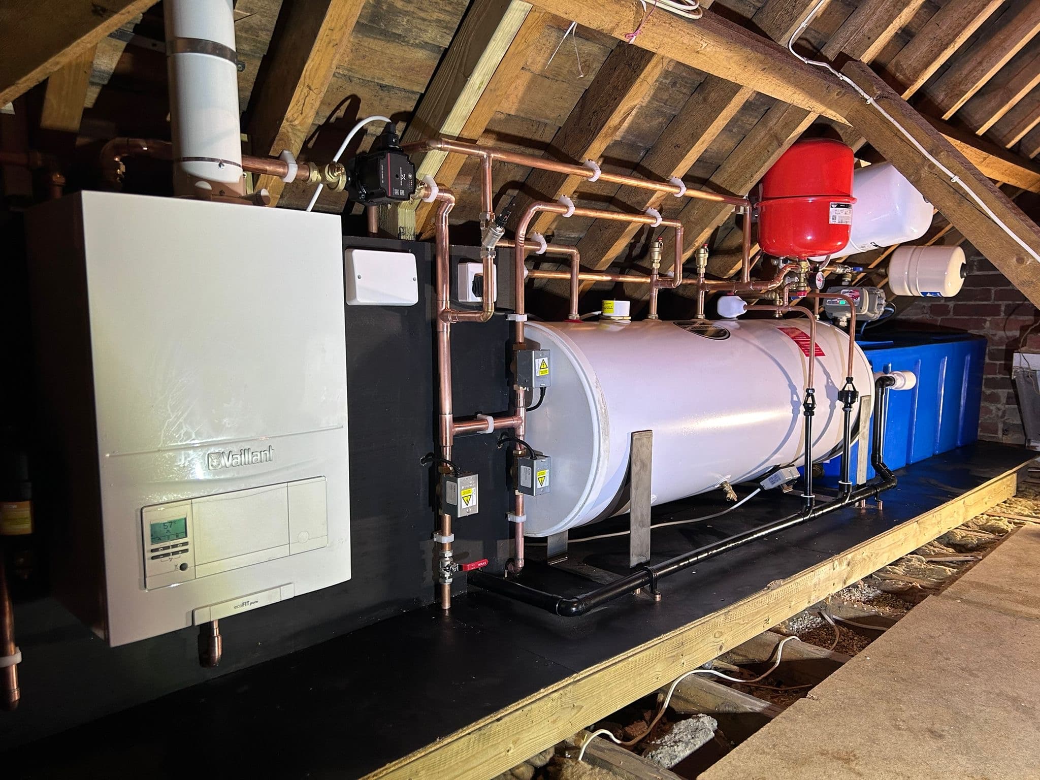 Loft plant room installed by Nichols Plumbing & Heating: Vaillant boiler, horizontal cylinder and expansion vessel with neat copper pipework