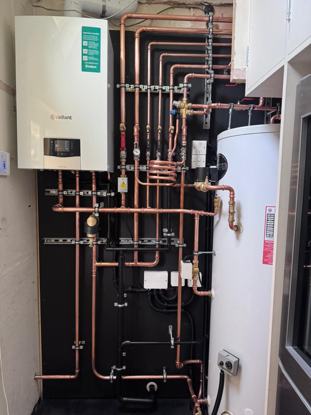 Multi-zone plant room: Vaillant system boiler and unvented cylinder with precision copper pipework
